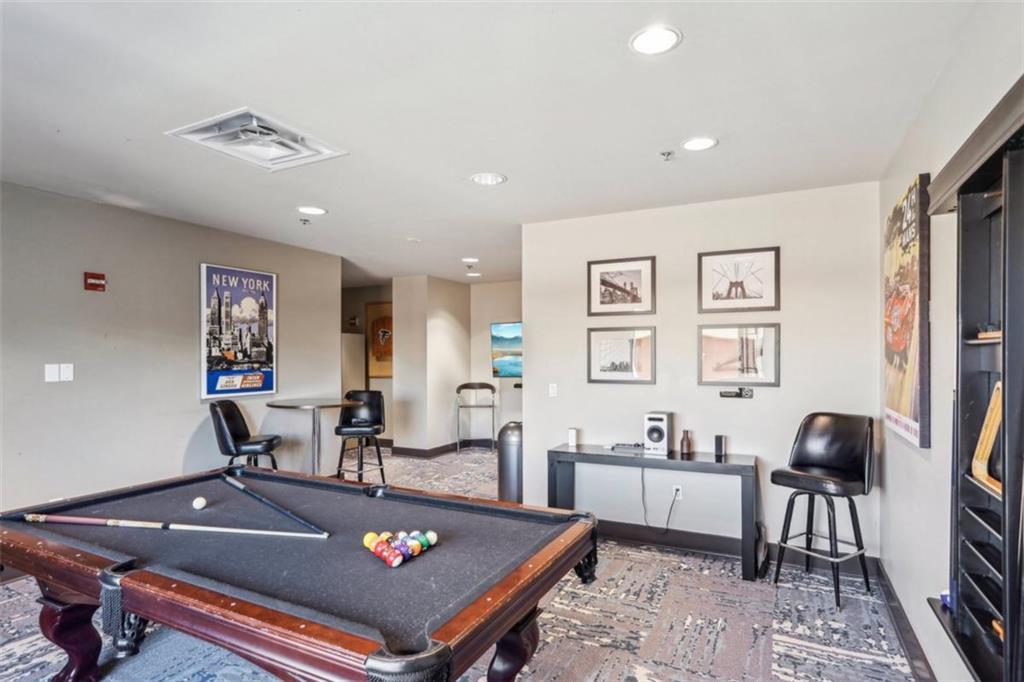 4561 Olde Perimeter Way, Unit 2609 Atlanta, GA 30346 - Photo 33 of 45 a living room with furniture and a flat screen tv