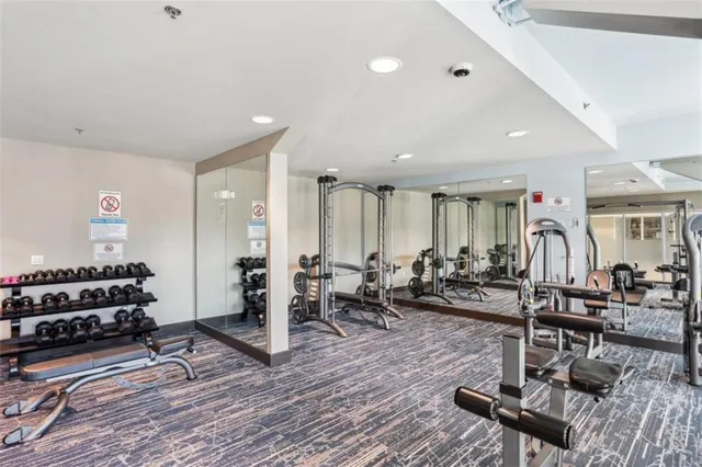 a living room with furniture a wooden floor and white walls