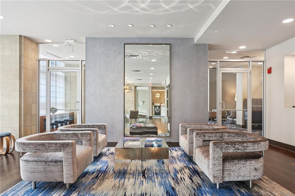 4561 Olde Perimeter Way, Unit 2609 Atlanta, GA 30346 - Photo 40 of 45 a living room with furniture and a large window