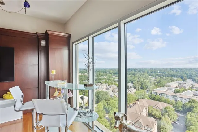 a living room with furniture and a floor to ceiling window