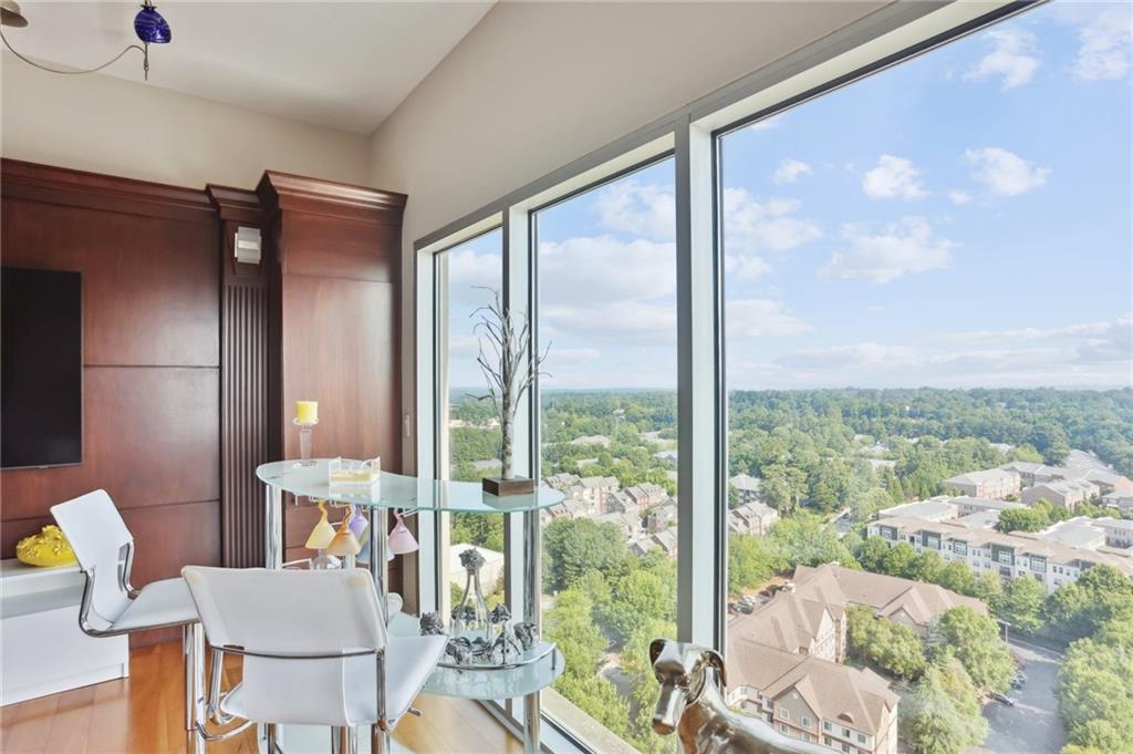 4561 Olde Perimeter Way, Unit 2609 Atlanta, GA 30346 - Photo 6 of 45 a living room with furniture and a floor to ceiling window