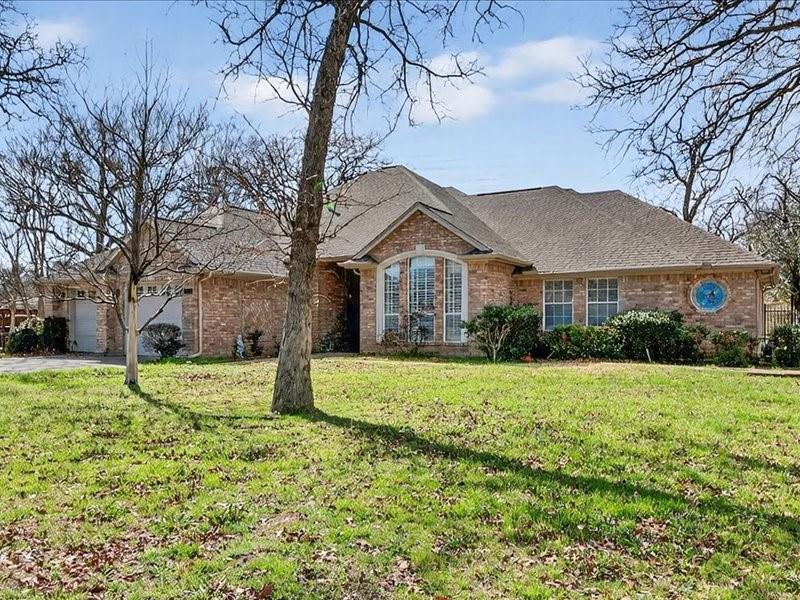 1704 South Bowen Road Pantego, TX 76013 - Photo 1 of 26 a front view of a house with a yard