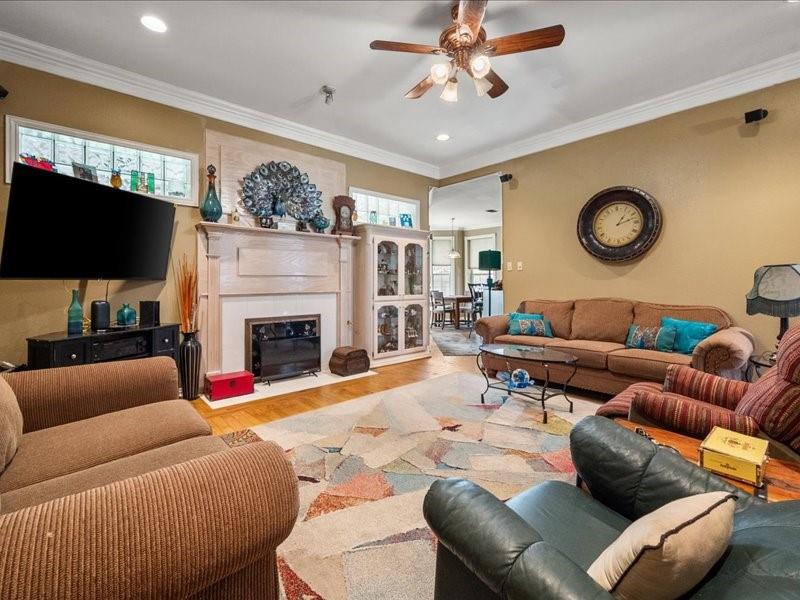 1704 South Bowen Road Pantego, TX 76013 - Photo 13 of 26 a living room with furniture a fireplace and a flat screen tv