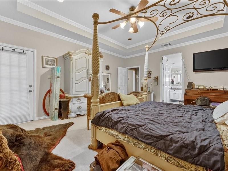 1704 South Bowen Road Pantego, TX 76013 - Photo 14 of 26 a bedroom with a bed couch and flat screen tv