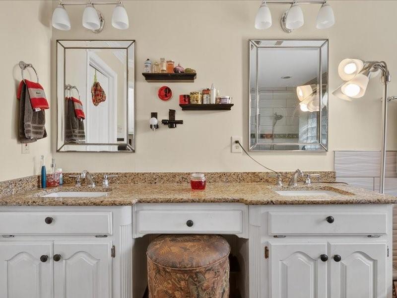 1704 South Bowen Road Pantego, TX 76013 - Photo 16 of 26 a bathroom with a sink vanity and mirror