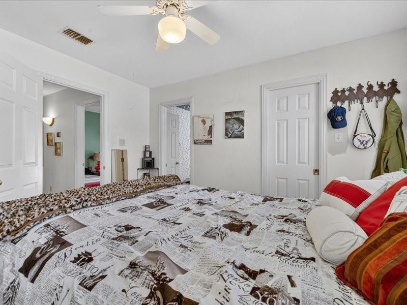 1704 South Bowen Road Pantego, TX 76013 - Photo 19 of 26 a bedroom with a bed and a chandelier