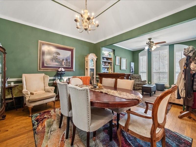 1704 South Bowen Road Pantego, TX 76013 - Photo 4 of 26 a view of a dining room with furniture and a chandelier fan