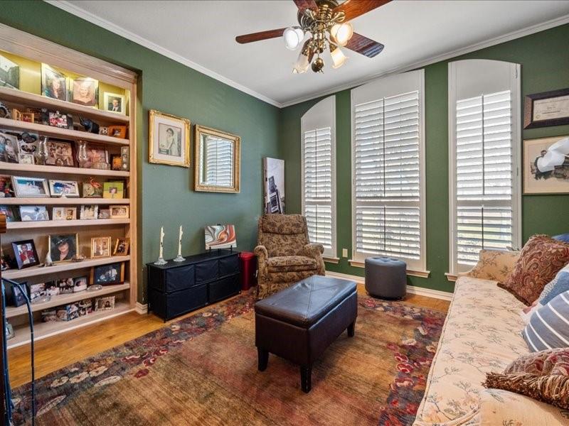 1704 South Bowen Road Pantego, TX 76013 - Photo 7 of 26 a living room with furniture and a book shelf