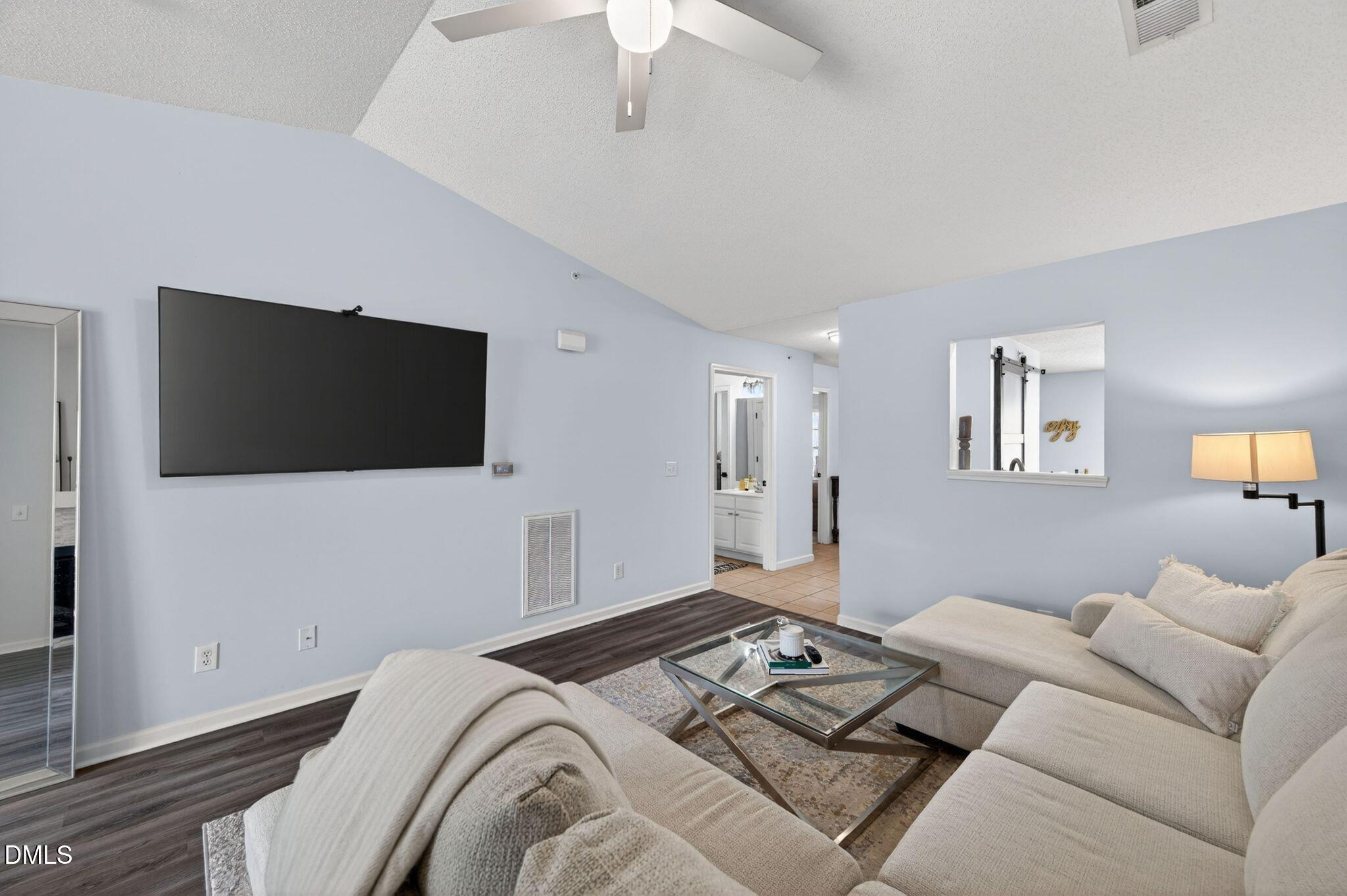 2400 Huntscroft Lane, Unit 202 Raleigh, NC 27617 - Photo 7 of 49 a bedroom with a bed and a flat screen tv