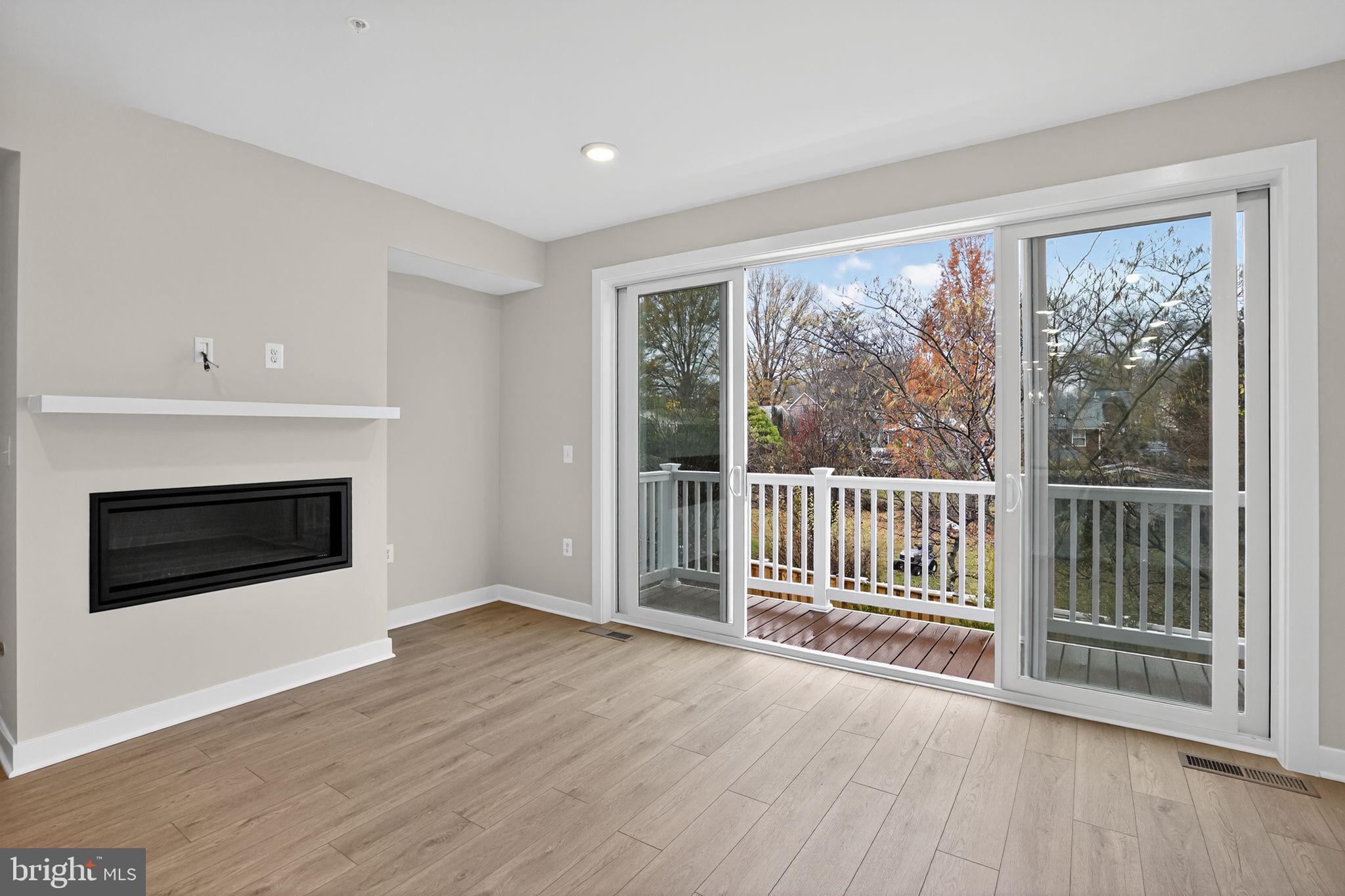 3612 Farr Avenue Fairfax, VA 22030 - Photo 11 of 30 a view of a livingroom with wooden floor and fireplace