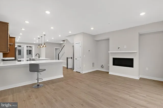 a view of kitchen with stainless steel appliances refrigerator stove microwave and cabinets