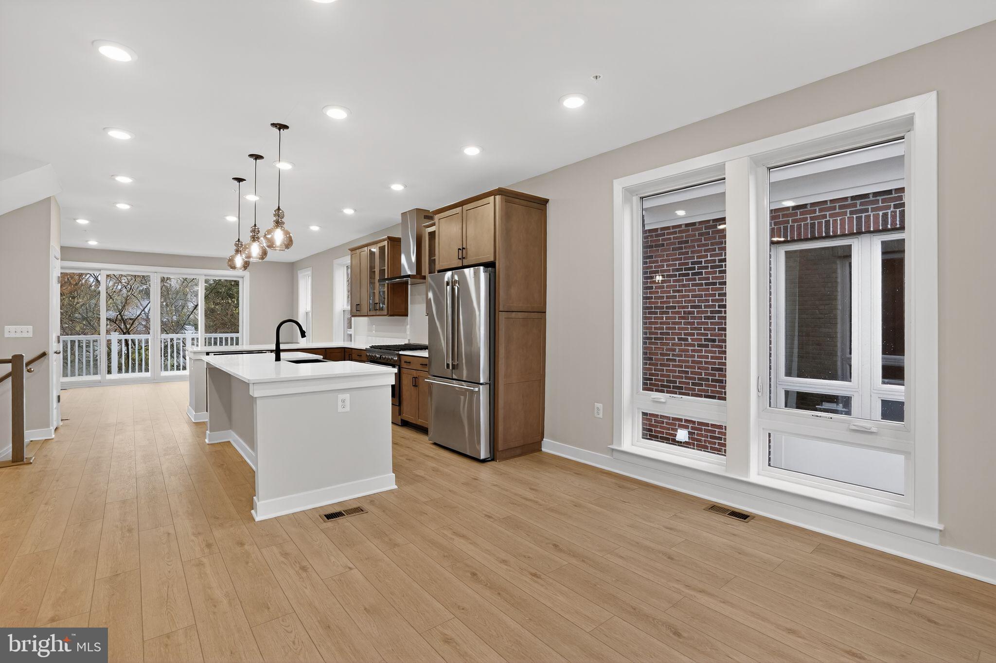3612 Farr Avenue Fairfax, VA 22030 - Photo 14 of 30 a view of kitchen with stainless steel appliances kitchen island wooden floors and large window