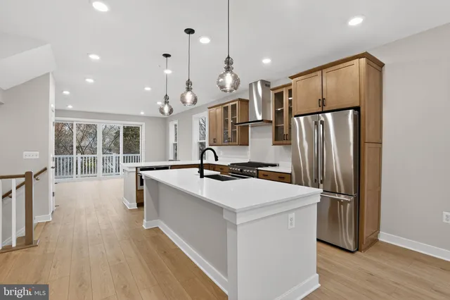 a kitchen with stainless steel appliances a refrigerator sink and stove