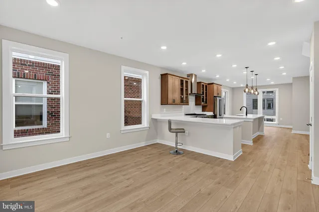 a view of kitchen with stainless steel appliances refrigerator oven and cabinets
