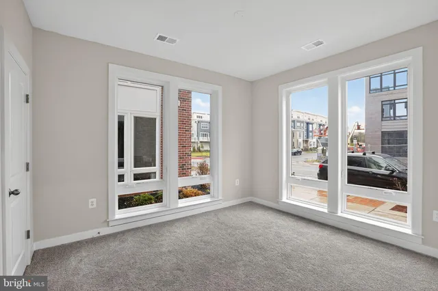 a view of a big room with windows and entryway