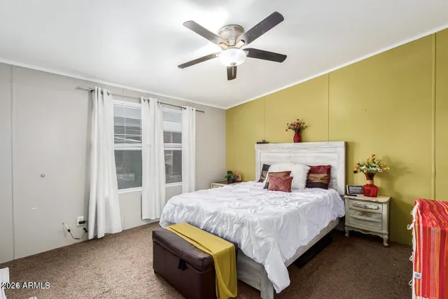 a bedroom with a bed and a large window