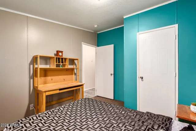 a room with a bed and a dresser