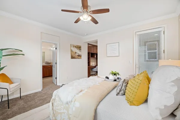 a bedroom with a large bed and a chandelier