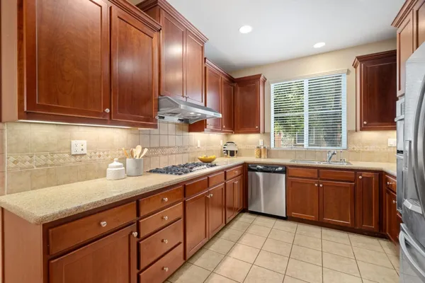 a kitchen with a sink stove and cabinets