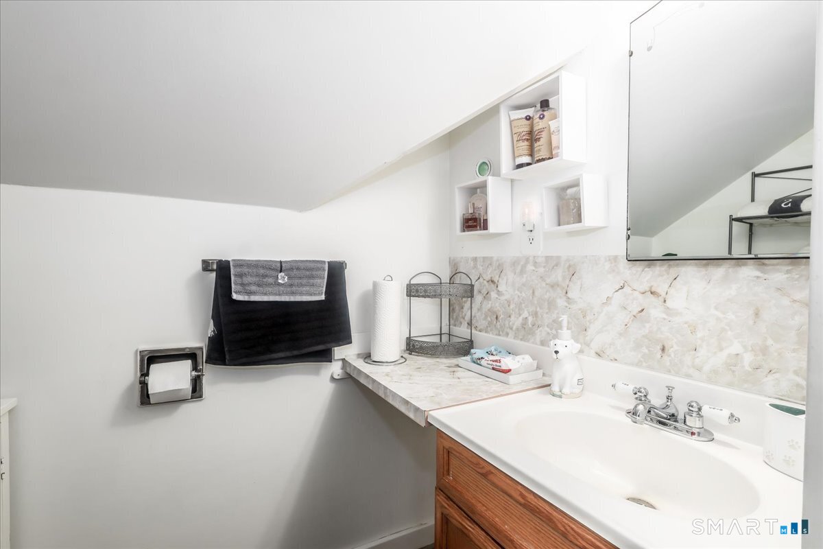 306 Welton Street Hamden, CT 06517 - Photo 30 of 38 a bathroom with a sink double vanity and a mirror