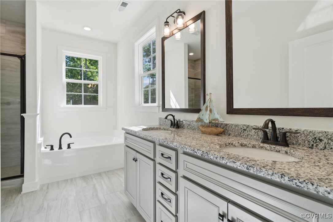340 Rainbow Ridge Bumpass, VA 23024 - Photo 14 of 29 a bathroom with double vanity sinks and a bathtub