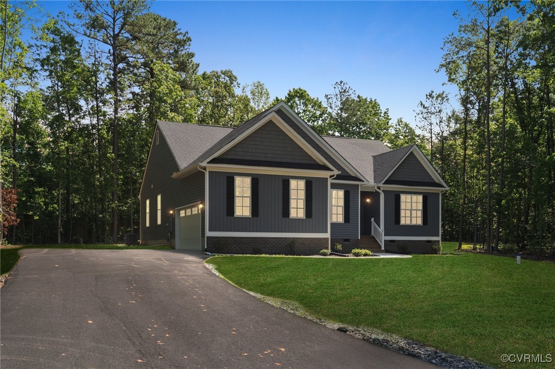 340 Rainbow Ridge Bumpass, VA 23024 - Photo 5 of 29 a front view of a house with a yard and garage