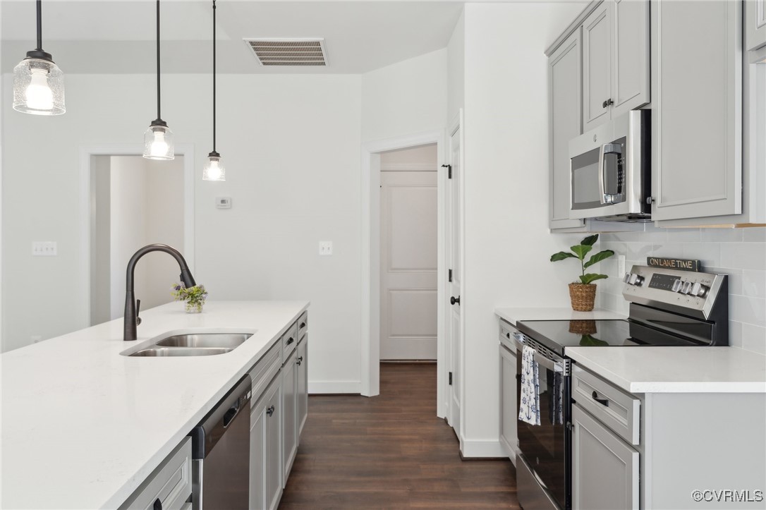 340 Rainbow Ridge Bumpass, VA 23024 - Photo 8 of 29 a kitchen with stainless steel appliances a sink a stove and a refrigerator