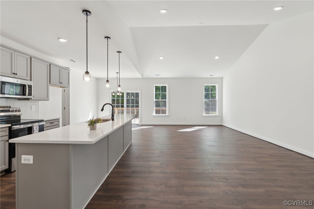 340 Rainbow Ridge Bumpass, VA 23024 - Photo 9 of 29 a large kitchen with stainless steel appliances a large counter top a sink a refrigerator and a window