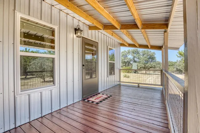 a view of porch with wooden floor and floor to ceiling window
