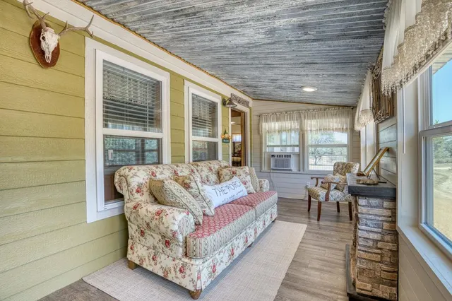 a balcony with furniture and a potted plant