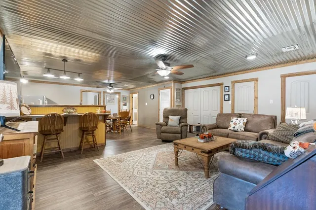 a living room with lots of furniture and wooden floor