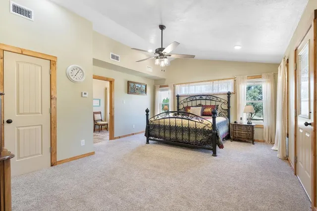 a bedroom with a bed dresser and a window