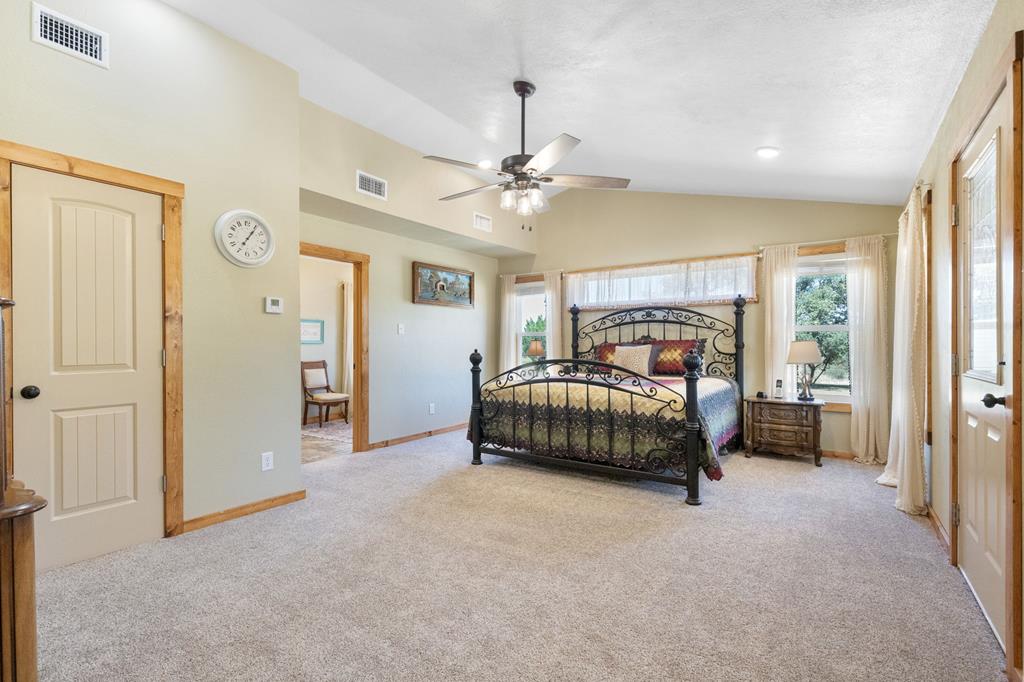 25525 Ranch Road 2323 Llano, TX 78643 - Photo 20 of 40 a bedroom with a bed dresser and a window