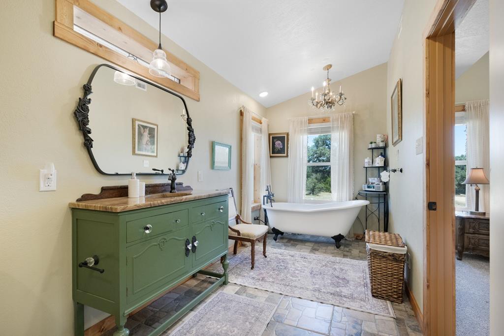 25525 Ranch Road 2323 Llano, TX 78643 - Photo 22 of 40 a spacious bathroom with a double vanity sink mirror and a bathtub