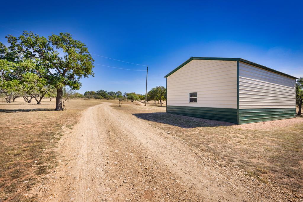 25525 Ranch Road 2323 Llano, TX 78643 - Photo 29 of 40 a view of backyard of house with trees
