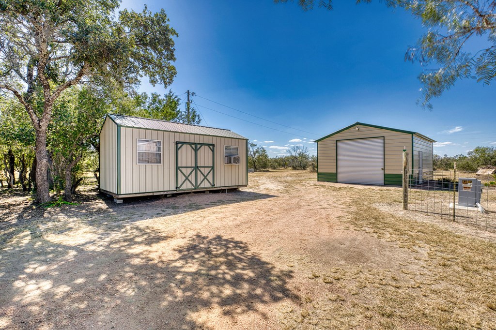 25525 Ranch Road 2323 Llano, TX 78643 - Photo 7 of 40 a front view of a house with a yard and garage