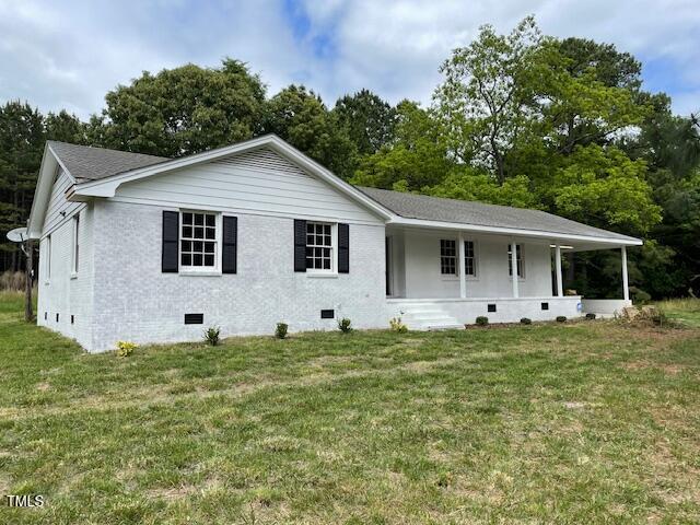 a big white house with a big yard and large trees