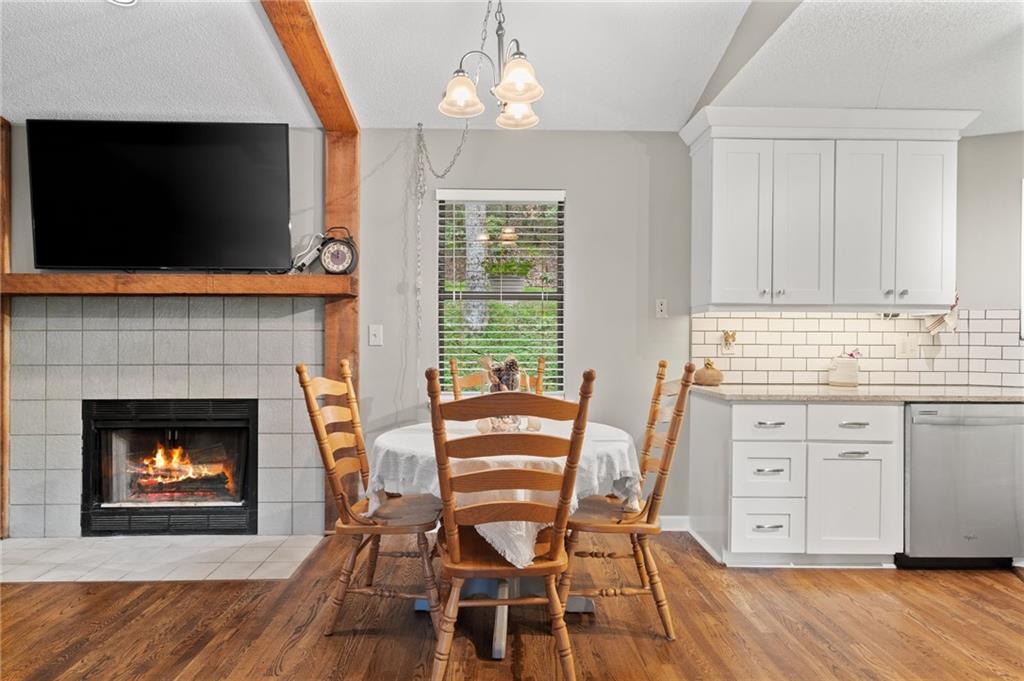 816 Mulligan Way Jasper, GA 30143 - Photo 11 of 36 a view of a dining room with furniture wooden floor and a fireplace