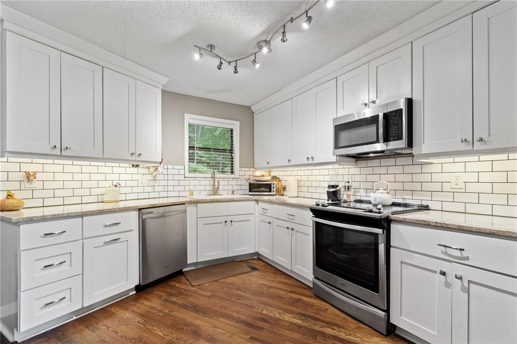 816 Mulligan Way Jasper, GA 30143 - Photo 12 of 36 a kitchen with appliances cabinets and a sink