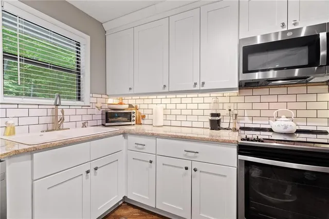 a kitchen with a sink stove and cabinets
