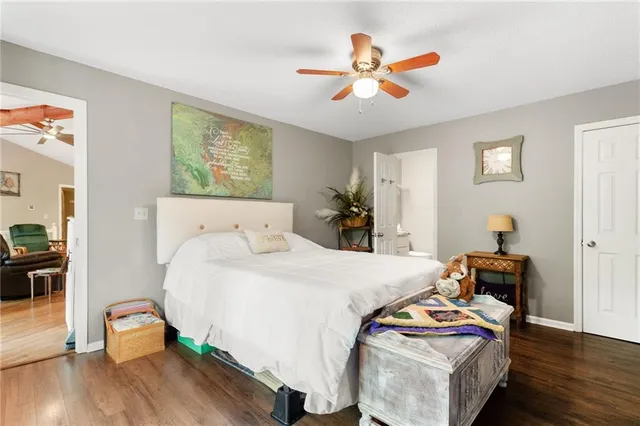a bedroom with bed and wooden floor