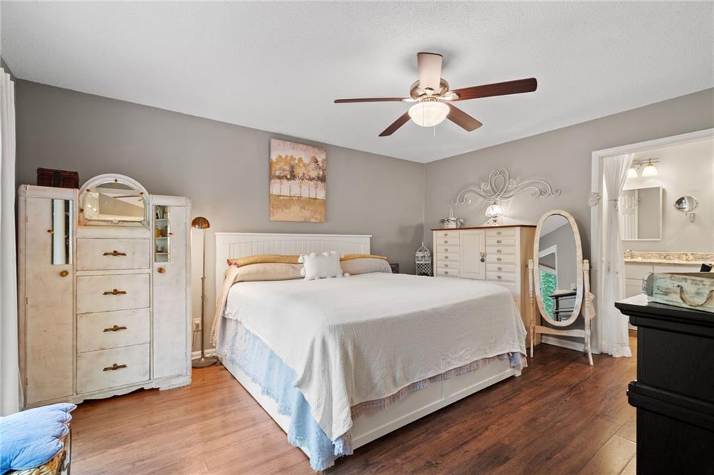 816 Mulligan Way Jasper, GA 30143 - Photo 18 of 36 a spacious bedroom with a bed and a cabinets