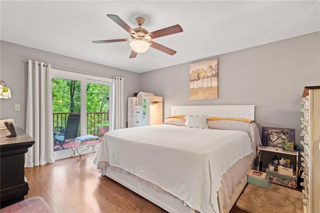 816 Mulligan Way Jasper, GA 30143 - Photo 19 of 36 a bedroom with a large bed and a chandelier