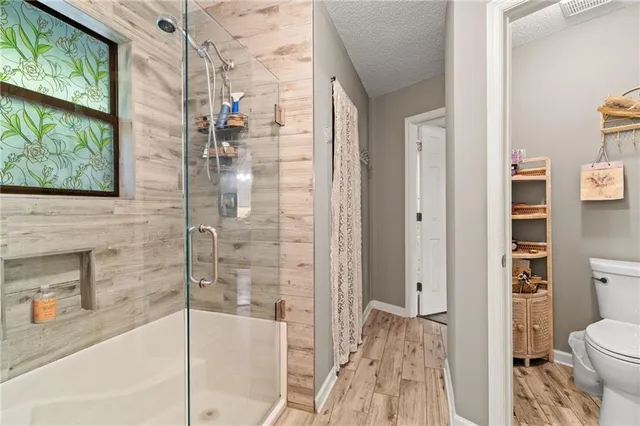 a bathroom with a granite countertop bathtub and a shower
