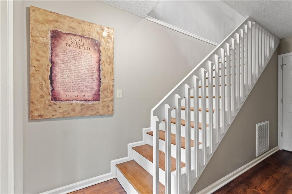 816 Mulligan Way Jasper, GA 30143 - Photo 22 of 36 a view of staircase with wooden floor and white walls