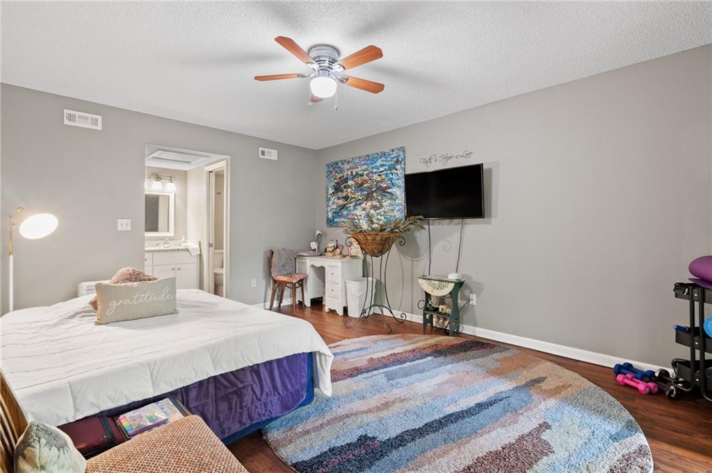 816 Mulligan Way Jasper, GA 30143 - Photo 23 of 36 a bedroom with a bed and a flat screen tv