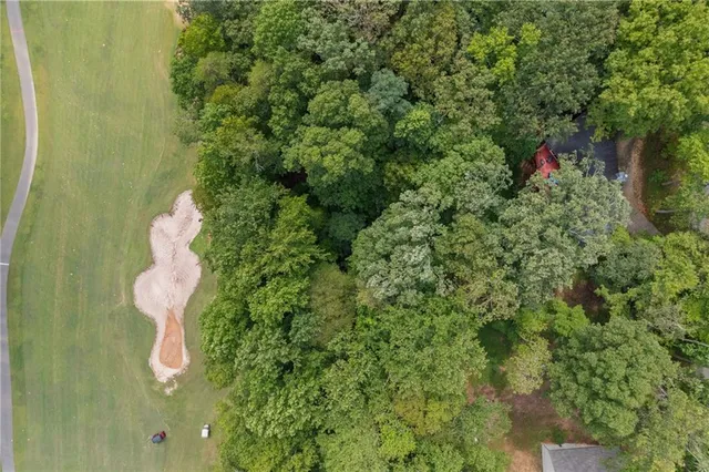 a backyard of a house with lots of green space and chair