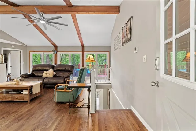 a view of a livingroom with workspace and a window