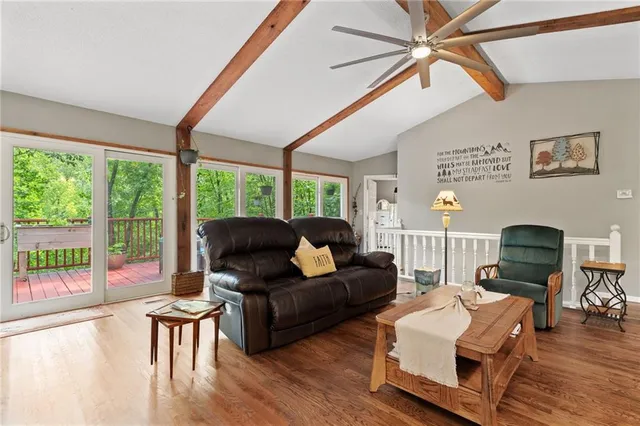 a living room with furniture and a floor to ceiling window