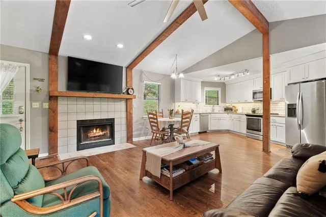 a living room with furniture fireplace and flat screen tv